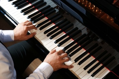 Man playing piano, above view. Talented musician