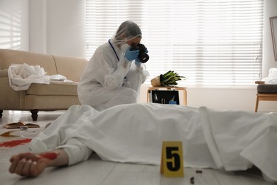 Investigator working at crime scene with dead body