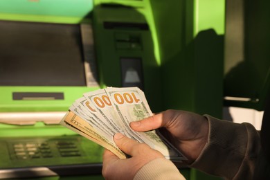 Photo of Man with money near cash machine, closeup
