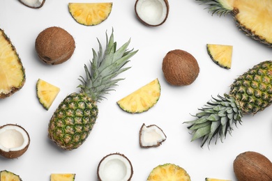 Composition with pineapple and coconut on white background, top view