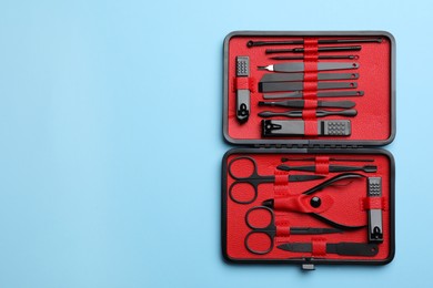 Photo of Manicure set in case on light blue background, top view. Space for text