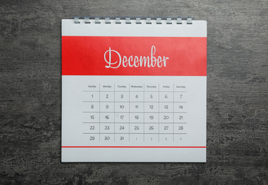 December calendar on grey stone background, top view