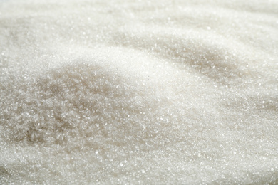 Pile of granulated sugar as background, closeup
