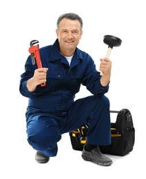 Mature plumber with pipe wrench and force cup on white background
