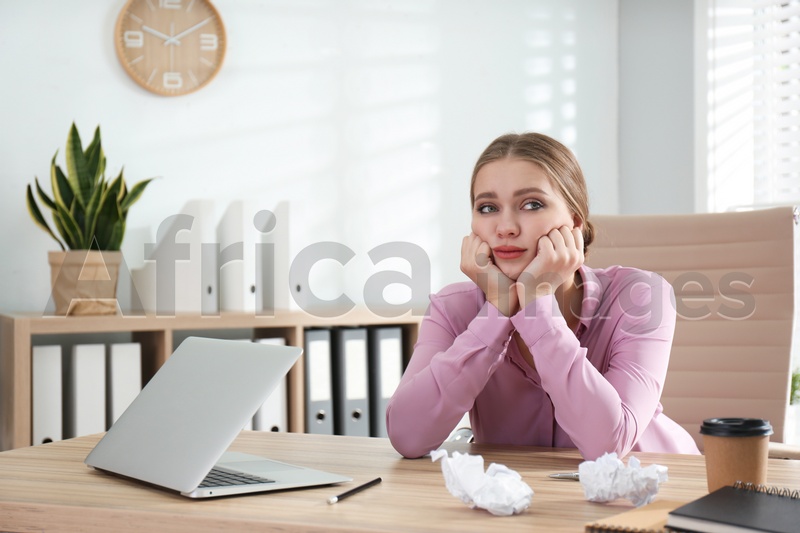 Lazy worker at wooden desk in office