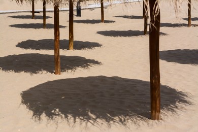 Shadows from umbrellas on sandy beach. Tropical resort