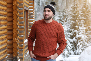 Happy man in warm sweater outdoors on winter day