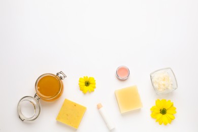 Flat lay composition with beeswax cosmetics on white background. Space for text