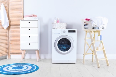 Washing machine with towels in laundry room interior