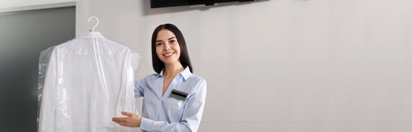Female worker with clean shirt, banner design. Dry-cleaning service