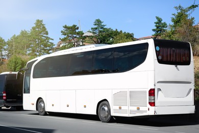 Modern white bus on road outdoors. Public transport
