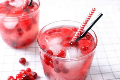 Glasses of natural lemonade with berries on table, closeup