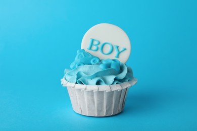 Baby shower cupcake with Boy topper on light blue background
