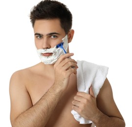 Handsome young man shaving with razor on white background