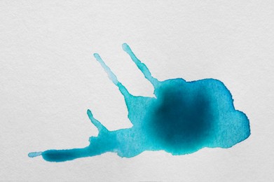 Photo of Light blue ink blots on white canvas, top view