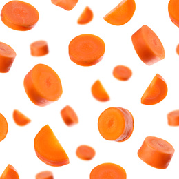 Fresh carrot slices falling on white background