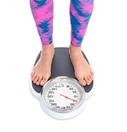 Young woman measuring her weight using scales on white background. Weight loss motivation
