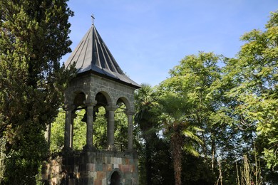 Photo of Exterior of beautiful bell tower in park on sunny day