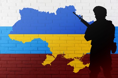 Image of Russian-Ukrainian war. Silhouette of soldier against brick wall with outline map of Ukraine and Russian flag