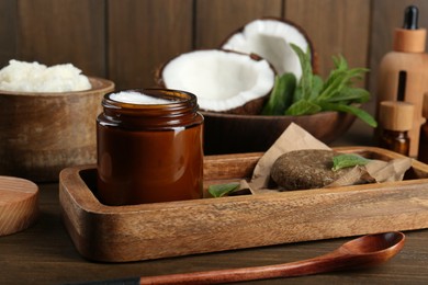 Photo of Homemade cosmetic products and fresh ingredients on wooden table, closeup