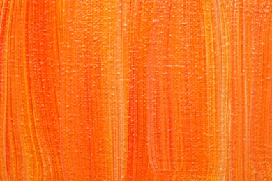 Beautiful strokes of orange oil paints as background, closeup