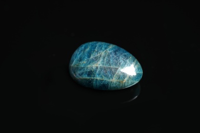 Photo of Beautiful blue apatite gemstone on black background