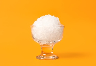 Shaving ice in glass dessert bowl on orange background