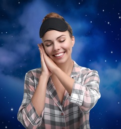 Beautiful woman and night starry sky on background. Bedtime