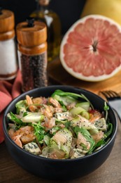Delicious pomelo salad with shrimps served on wooden table