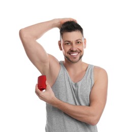 Handsome man applying deodorant isolated on white