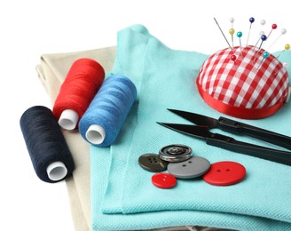 Photo of Spools of threads and sewing tools on white background