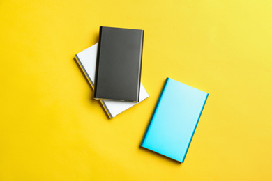 Modern external portable chargers on yellow background