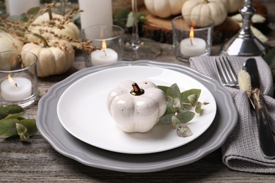 Beautiful autumn place setting and decor on wooden table