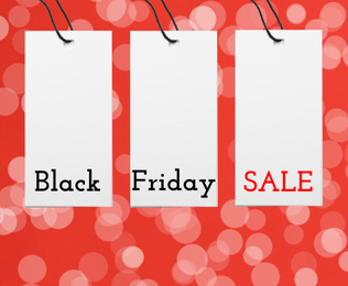 Different tags on color background, flat lay. Black Friday 
