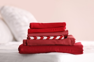 Clean color folded linens on bed indoors