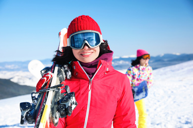 Young woman with ski at resort. Winter vacation
