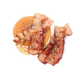 Delicious pancakes with maple syrup and fried bacon on white background, top view