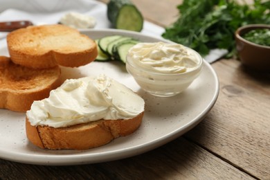 Delicious sandwich with cream cheese on wooden table, closeup