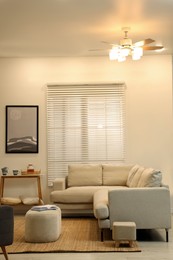 Photo of Stylish living room interior with comfortable sofa and ottoman