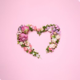 Beautiful heart made of different flowers on pink background, flat lay. Space for text