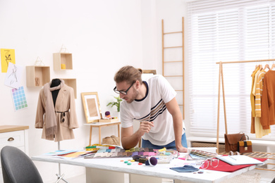 Photo of Fashion designer creating new clothes in studio