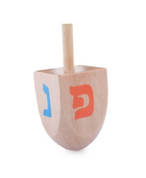 Wooden Hanukkah traditional dreidel with letters Nun and Pe isolated on white