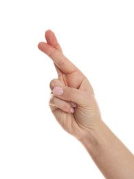 Woman holding fingers crossed on white background, closeup. Superstition for good luck