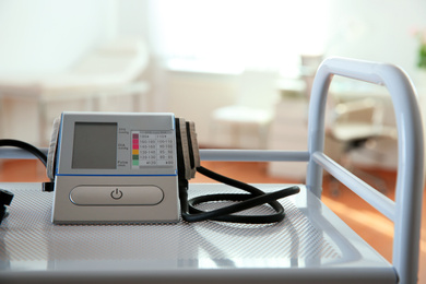Modern blood pressure monitor on cart in medical office
