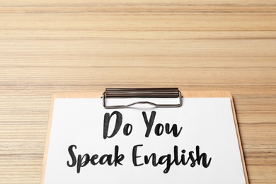 Clipboard with question Do You Speak English on wooden table, closeup. Space for text