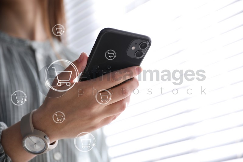 Delivery concept. Woman using modern mobile phone for online shopping indoors, closeup. Market cart illustrations
