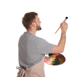 Man painting with brush on white background. Young artist