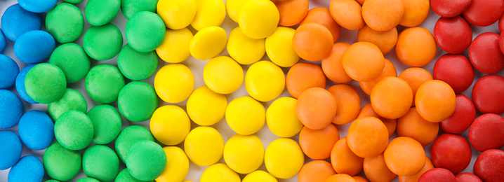 Many colorful candies as background, top view. Banner design 