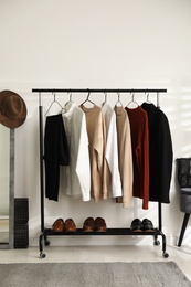 Rack with stylish men's clothes indoors. Interior design