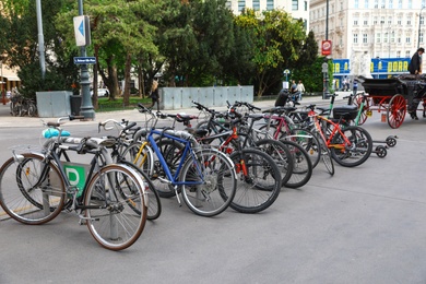 VIENNA, AUSTRIA - APRIL 26, 2019: Different bicycles parked near road on sidewalk